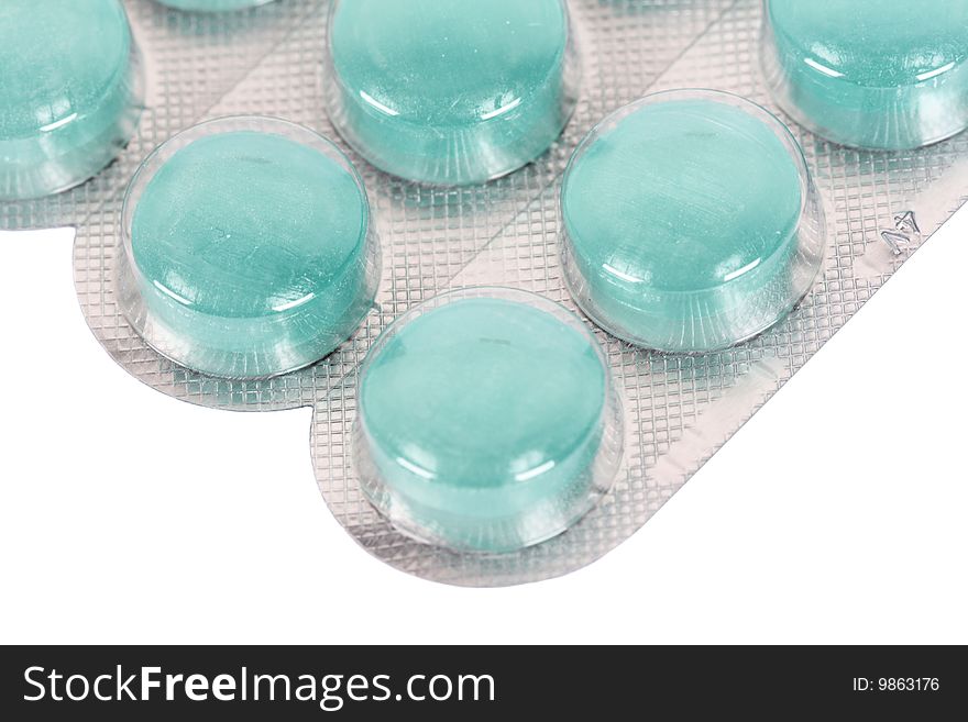 Close up of blue pills in their packages on a white background. Close up of blue pills in their packages on a white background
