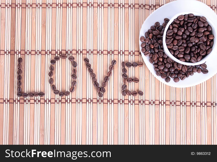 Coffee cup with coffee beans with and a word love