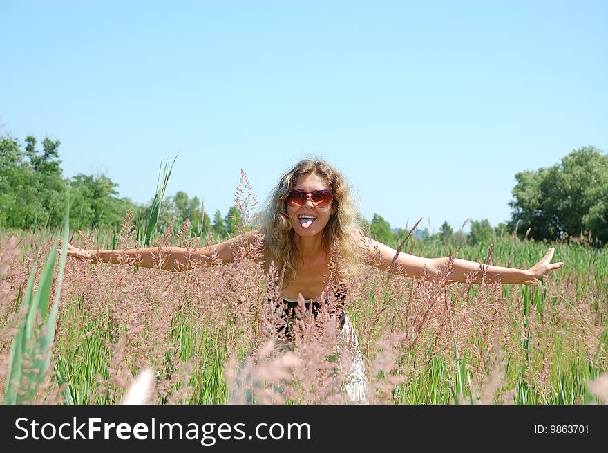 Adorable young woman jumping in the floral field. Adorable young woman jumping in the floral field
