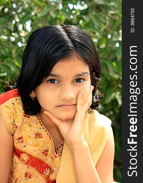 A small Indian girl with her bright and positive expressions.