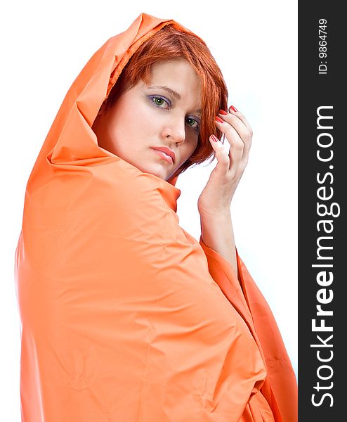 Red-haired girl in red cover on a white background. Red-haired girl in red cover on a white background