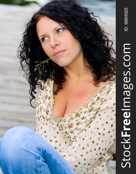 Beautiful brunet woman sitting on wooden floor