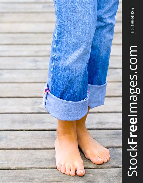 Female legs standing on toes on a wooden floor