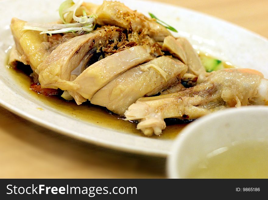 A plate of drumstick Chicken with soup. A plate of drumstick Chicken with soup