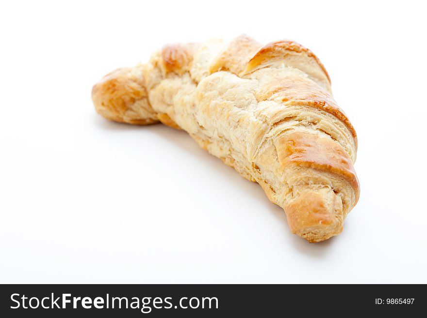 Freshly baked croissant on a white background