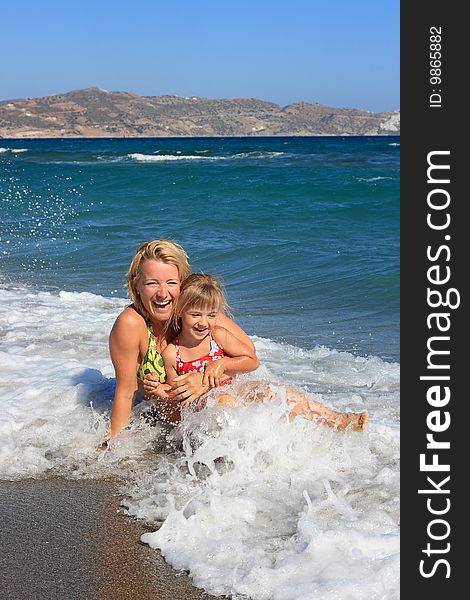 Happy mum with a daughter have a rest on the sea