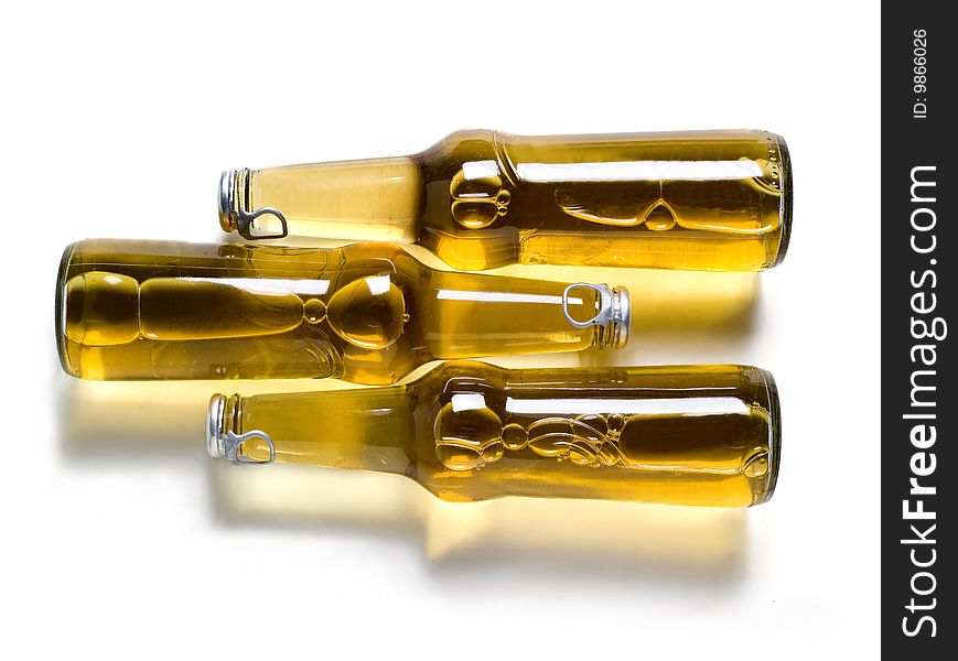 three bottle of beer with shadows on a white background