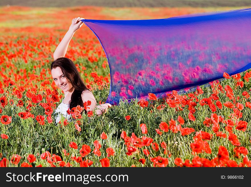 Smiling girl in the poppy field