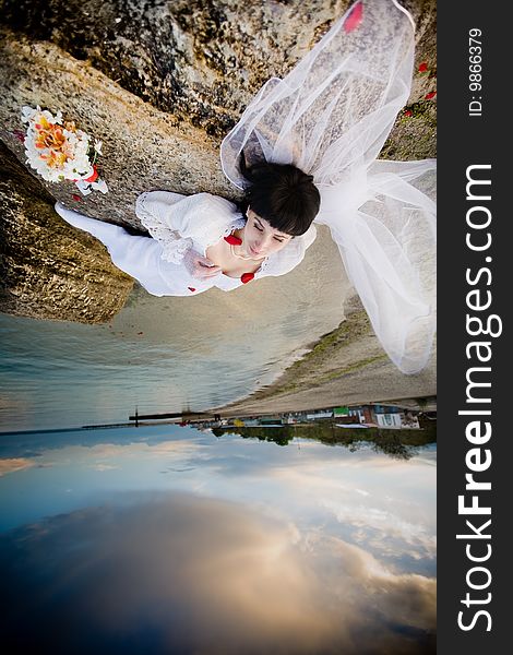 Beautiful bride in white dress on the beach. Beautiful bride in white dress on the beach