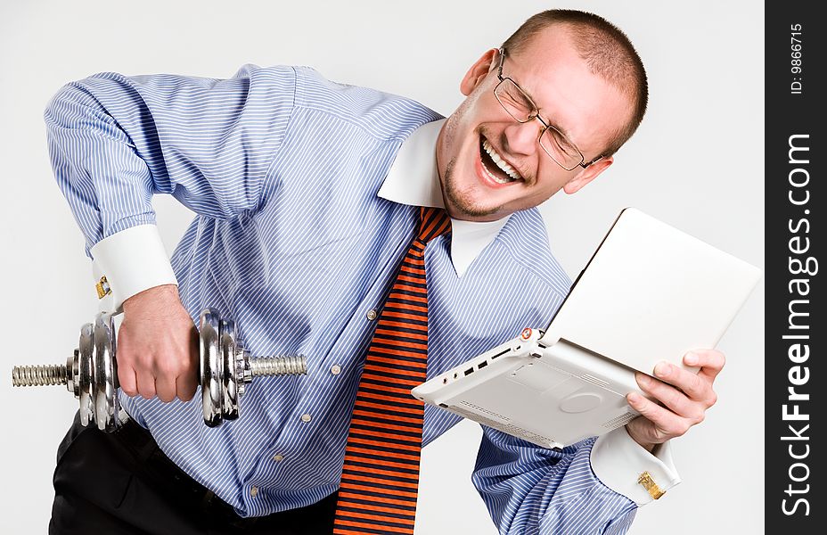 Businessman lifting dumbbell with laptop. Businessman lifting dumbbell with laptop