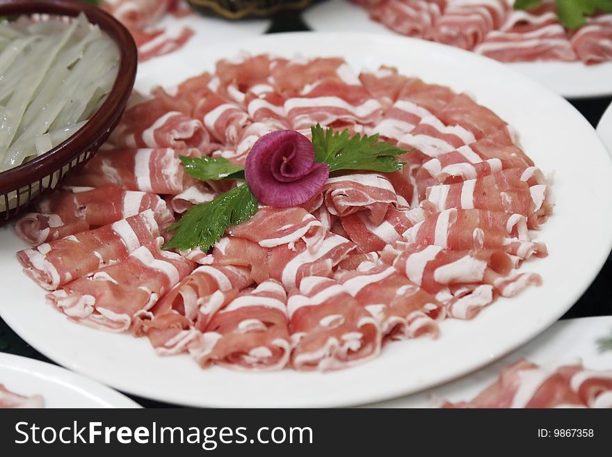 Close-up of Sheep's meat slices. Main dish of the Chinese instant boiled mutton . Close-up of Sheep's meat slices. Main dish of the Chinese instant boiled mutton .