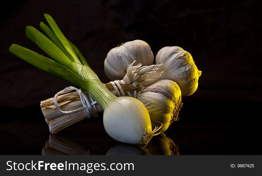 Garlic & Spring Onion on black marble worktop