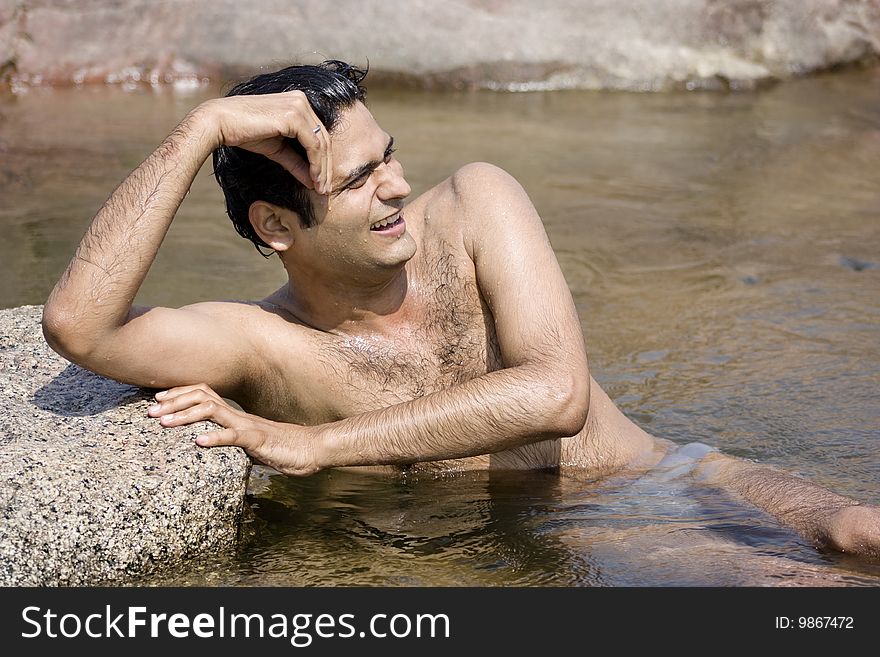 Happy young man enjoying and relaxing  on the river. Happy young man enjoying and relaxing  on the river