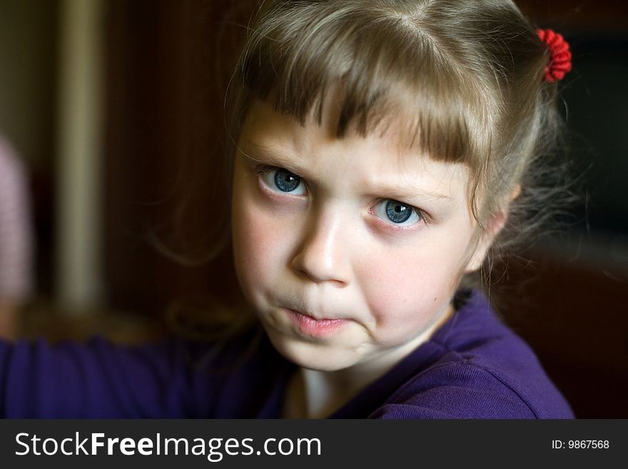 An image of a portrait of a sad little girl. An image of a portrait of a sad little girl
