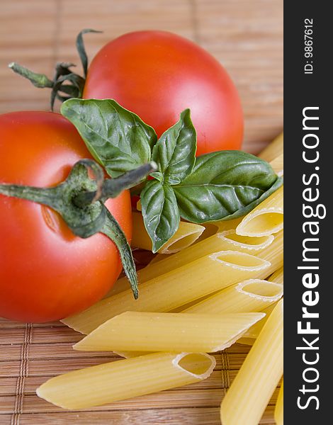 Raw pasta with fresh tomatoes and basil. Raw pasta with fresh tomatoes and basil