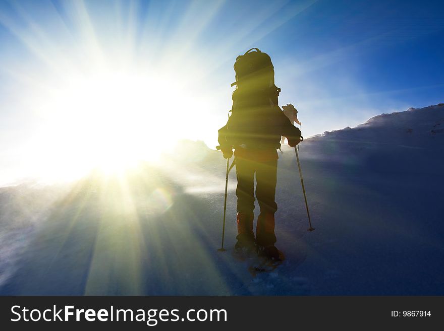 Hiker in winter in mountains