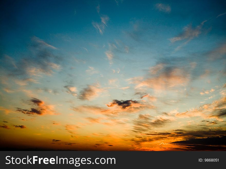 Bright glowing sunset on the dark blue sky