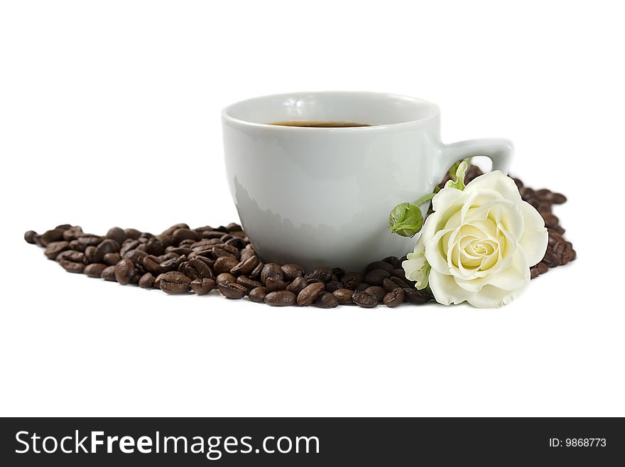 A cup of coffee with white rose and coffee beans isolated on white background