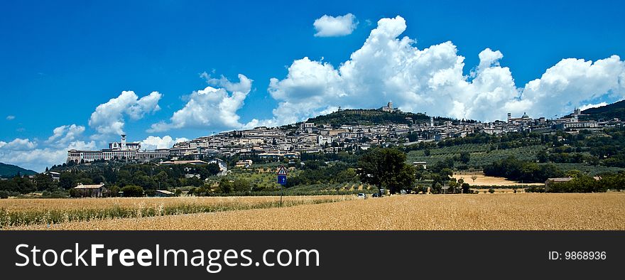 Assisi is surrounded by crops and agricultural landscapes. Basilica and friary, as seen from the plain below. Assisi is surrounded by crops and agricultural landscapes. Basilica and friary, as seen from the plain below