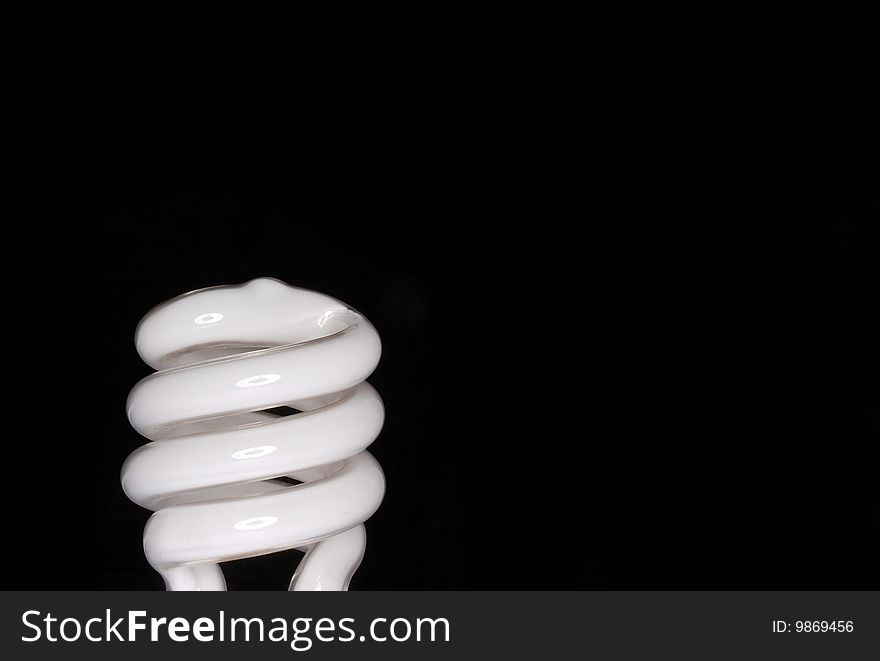 Shot of flourescent light bulb on black background. Shot of flourescent light bulb on black background