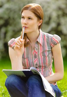 Pretty Girl Studying Outdoors Stock Photo