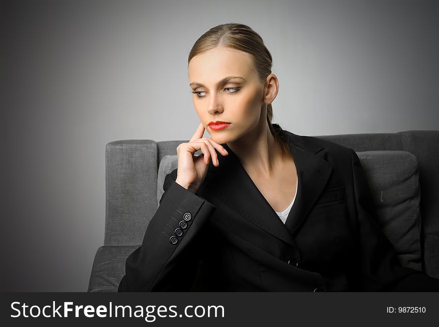 Portrait of beautiful business woman sitting on armchair