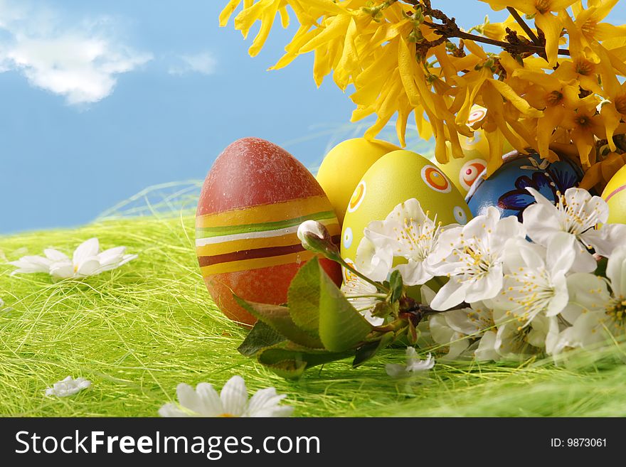 Easter Eggs sitting on grass field with blue sky background