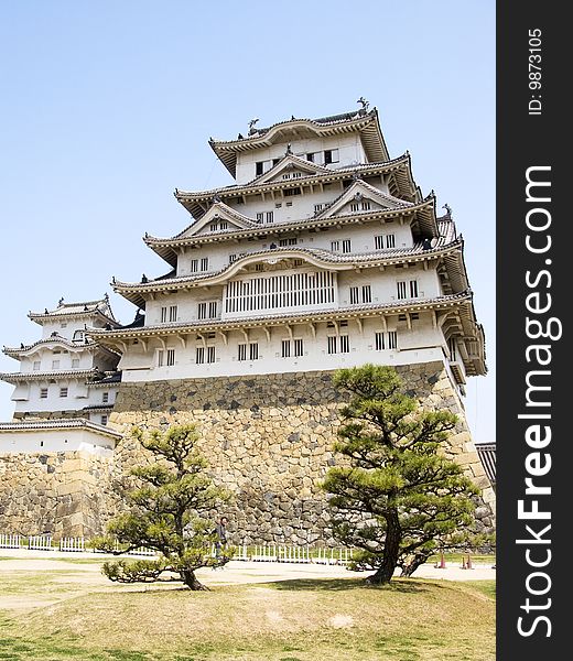 Himeji castle front view from the main hill with a couple of trees. Himeji castle front view from the main hill with a couple of trees