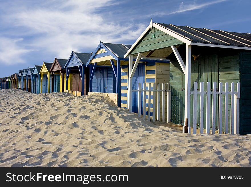 Beach Cabins on a sandy beach on a sunny day with a blue sky