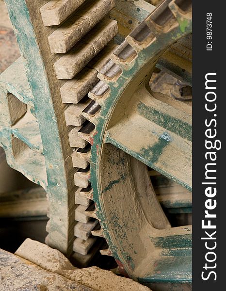 Close up of some large wooden gear wheels wheels meshed together