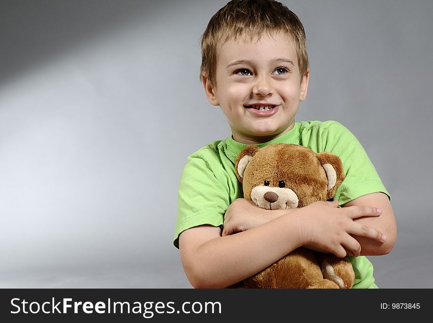 Portrait of cute boy having fun and smiling with small bear. Portrait of cute boy having fun and smiling with small bear
