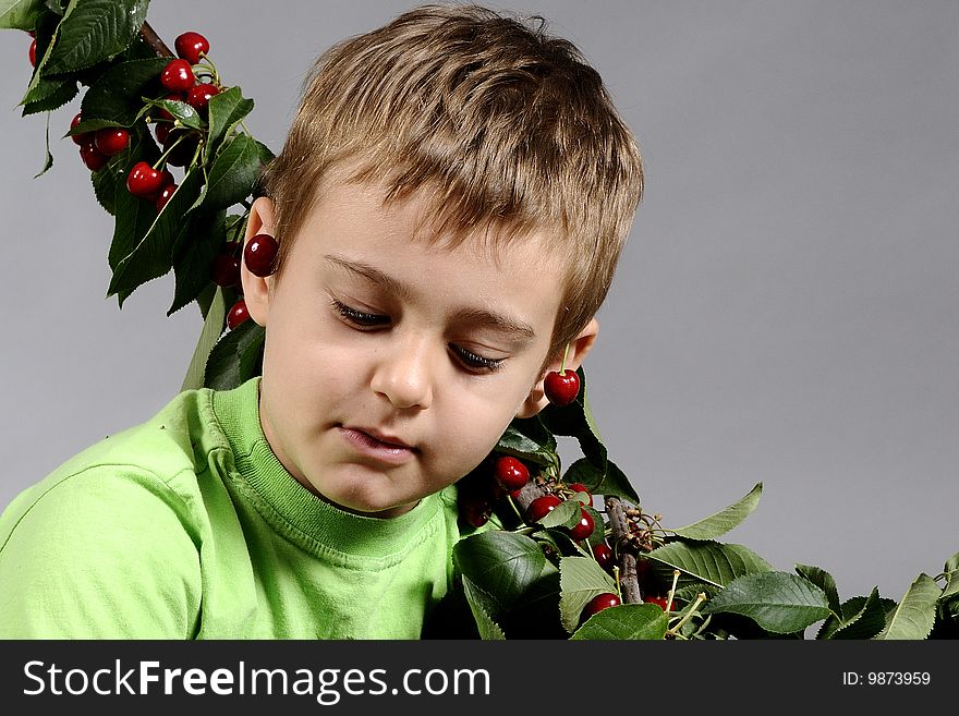 Portrait of small boy with a lot of cherries. Portrait of small boy with a lot of cherries