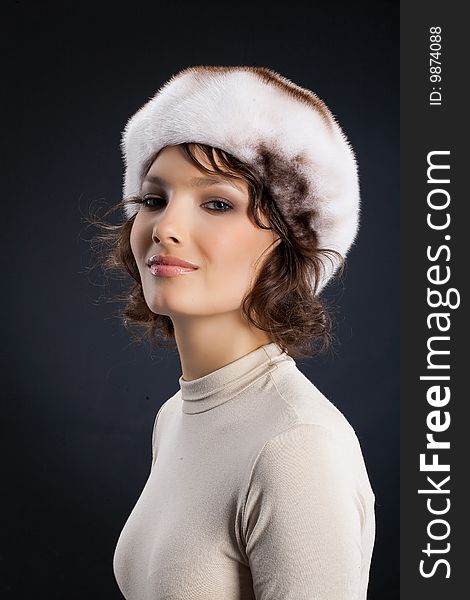 Young attractive woman in a fur hat