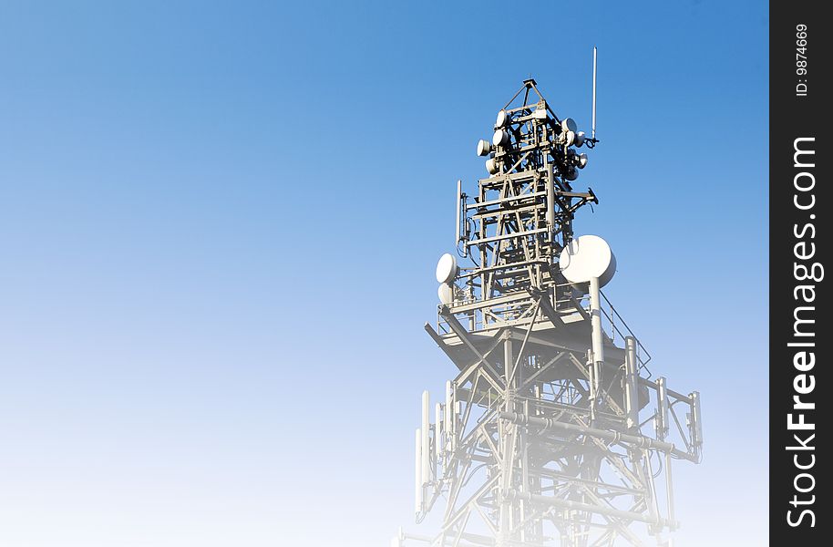 Communications concept showing mast overlaid with blue to white color. Communications concept showing mast overlaid with blue to white color