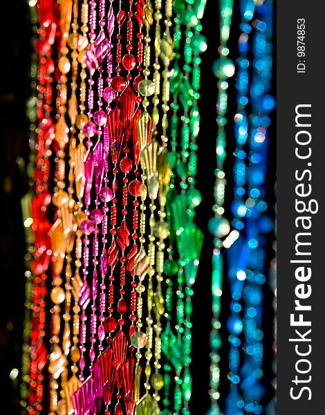 Colourful beads hanging in a doorway.