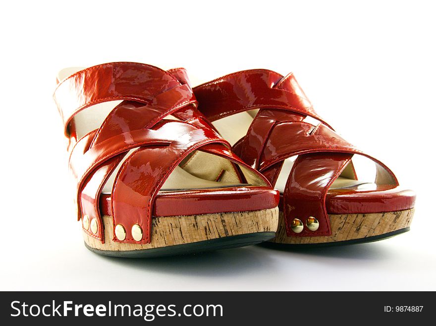 Pair of platform heeled red shoes with clipping path on a white background