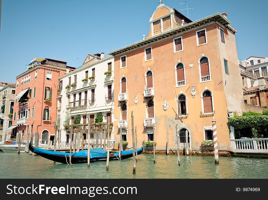 Gondola parked next a house. Canals of Venice