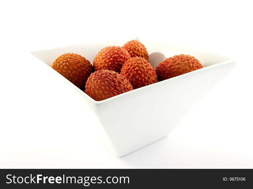 Group of lychee in a dish with clipping on a white background