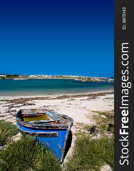 Old blue wooden boat on the sandy shore. Old blue wooden boat on the sandy shore.