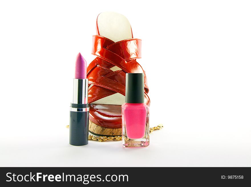 Single red shoe with lipstick, nail polish and gold bracelet with clipping path on a white background. Single red shoe with lipstick, nail polish and gold bracelet with clipping path on a white background