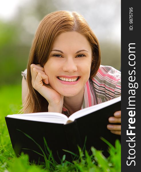 Pretty girl reading a book outdoors. Pretty girl reading a book outdoors