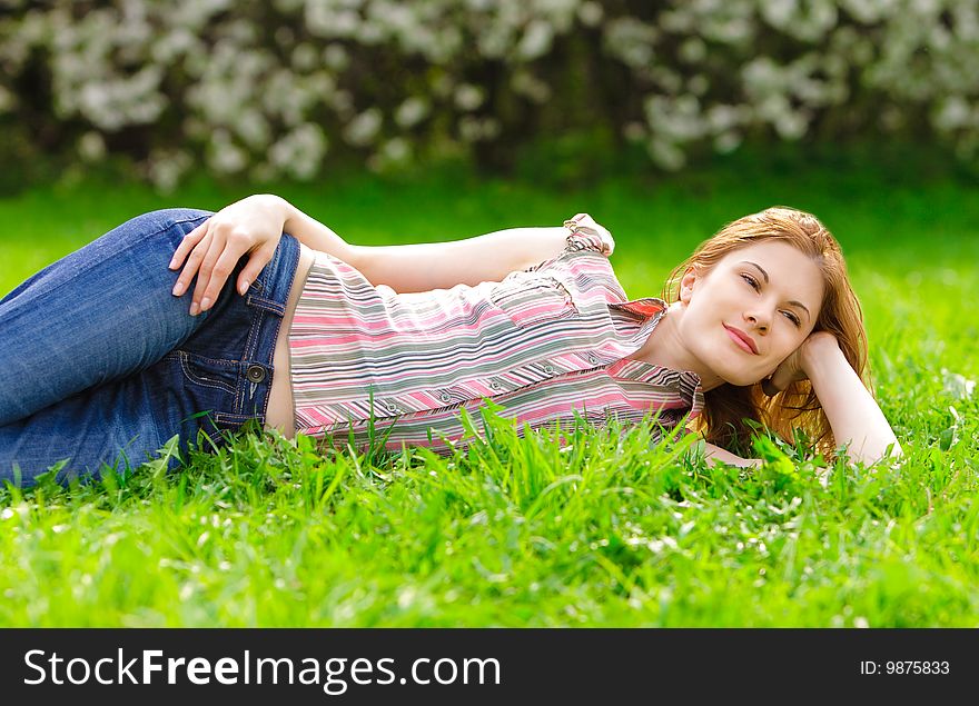 Pretty girl relaxing in a park. Pretty girl relaxing in a park