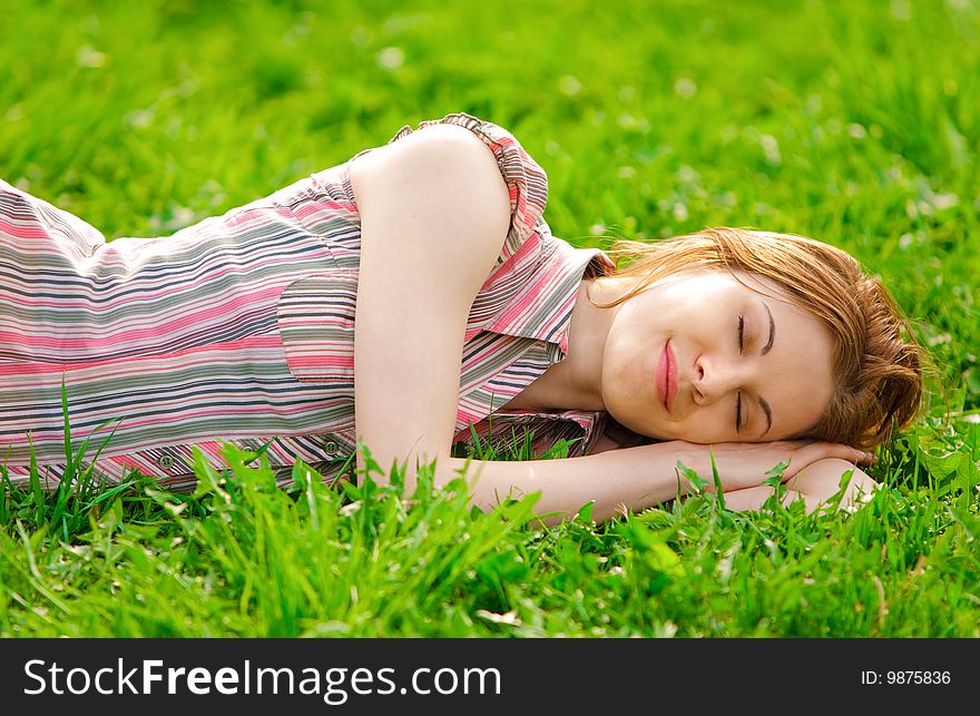 Pretty girl laying on a grass. Pretty girl laying on a grass