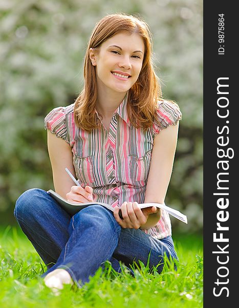 Pretty girl studying in a park. Pretty girl studying in a park