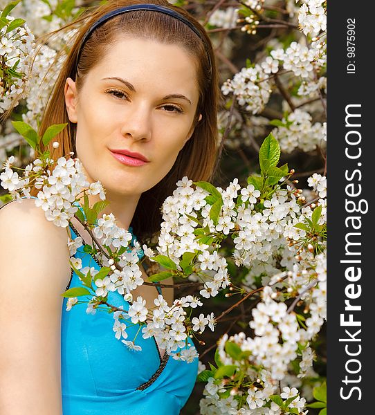 Beautiful young woman with in flowers outdoors. Beautiful young woman with in flowers outdoors