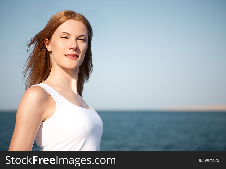 Beautiful young woman relaxing on the beach. Beautiful young woman relaxing on the beach