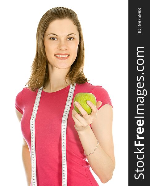 Beautiful girl holding an apple and a measure tape
