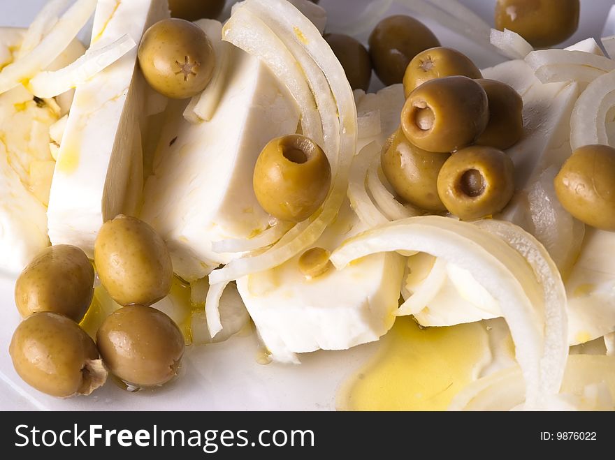Piece of cheese, olives and oil. Piece of cheese, olives and oil