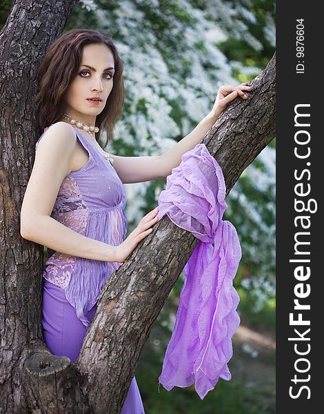 Tender girl in the garden with flowerings trees