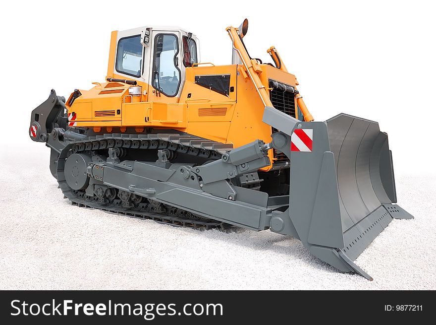 Yellow bulldozer over white gravel